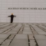 a man standing in front of a wall with his arms outstretched