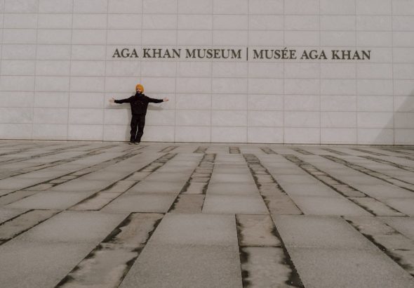 a man standing in front of a wall with his arms outstretched