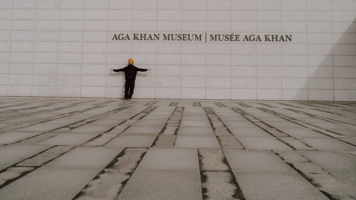 a man standing in front of a wall with his arms outstretched