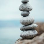 a stack of rocks sitting on top of a rocky beach