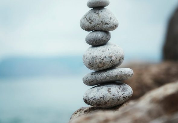 a stack of rocks sitting on top of a rocky beach