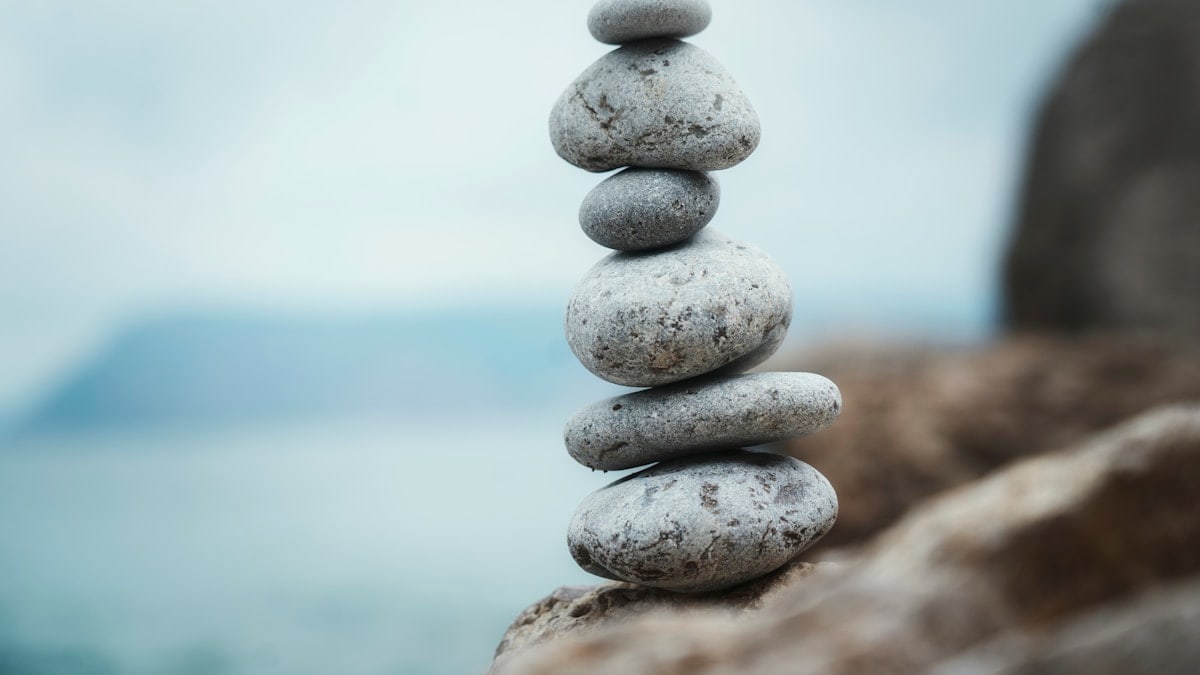 a stack of rocks sitting on top of a rocky beach